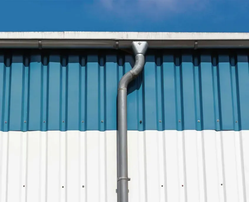 Large blue and white warehouse with commercial gutter system