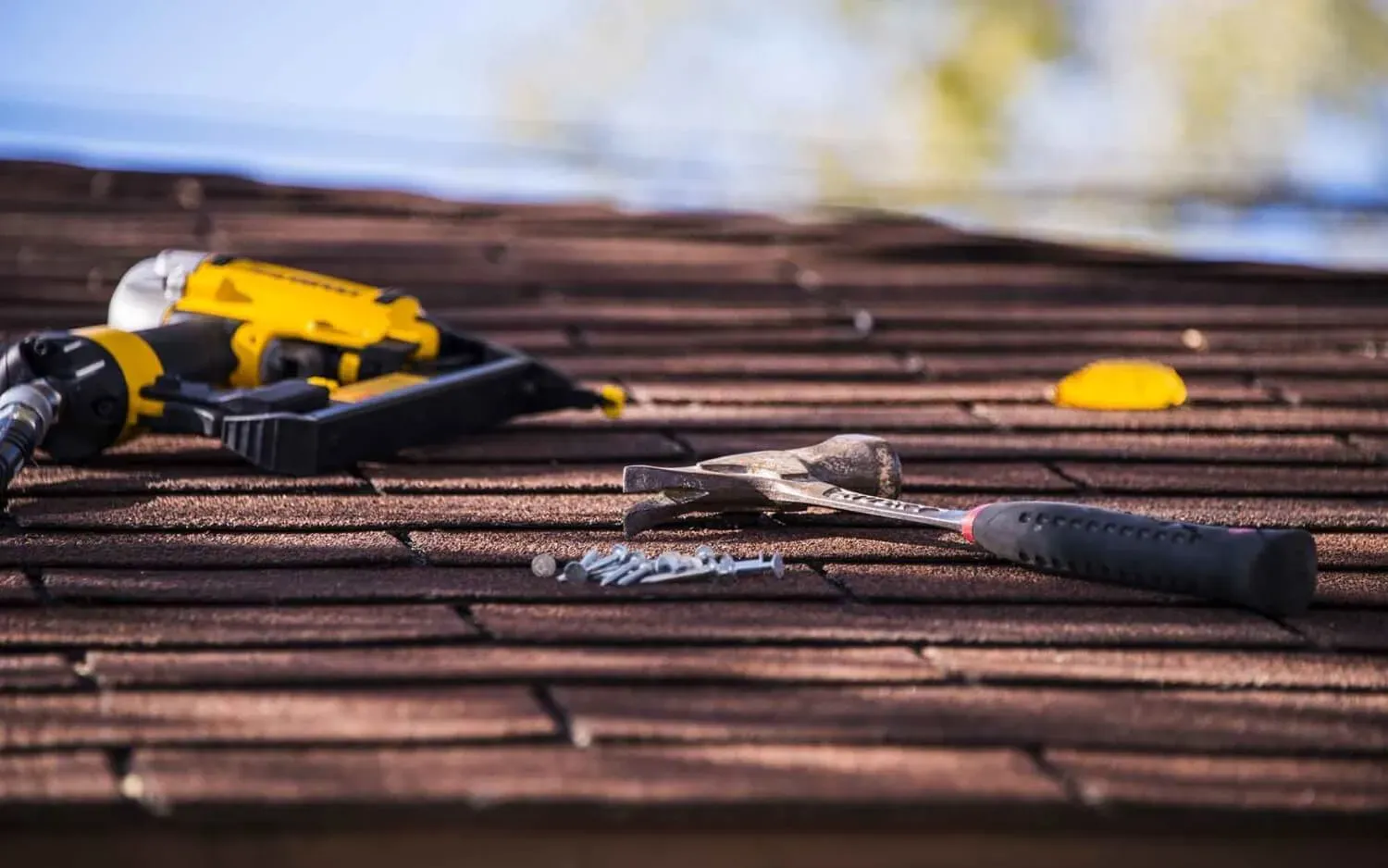 New_Image_Roof_A hammer and nail gun on top of roof