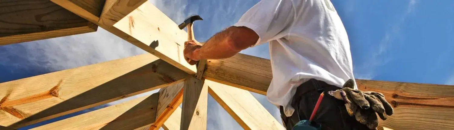 New_Image_Roof_worker hamming in nails on roof frame