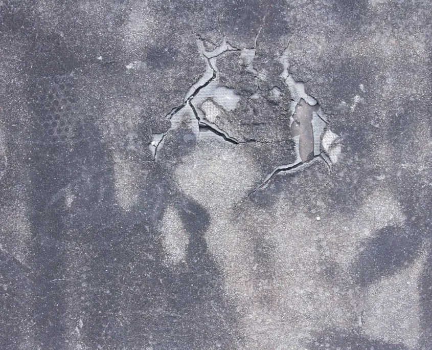 Sun damaged commercial flat roof material