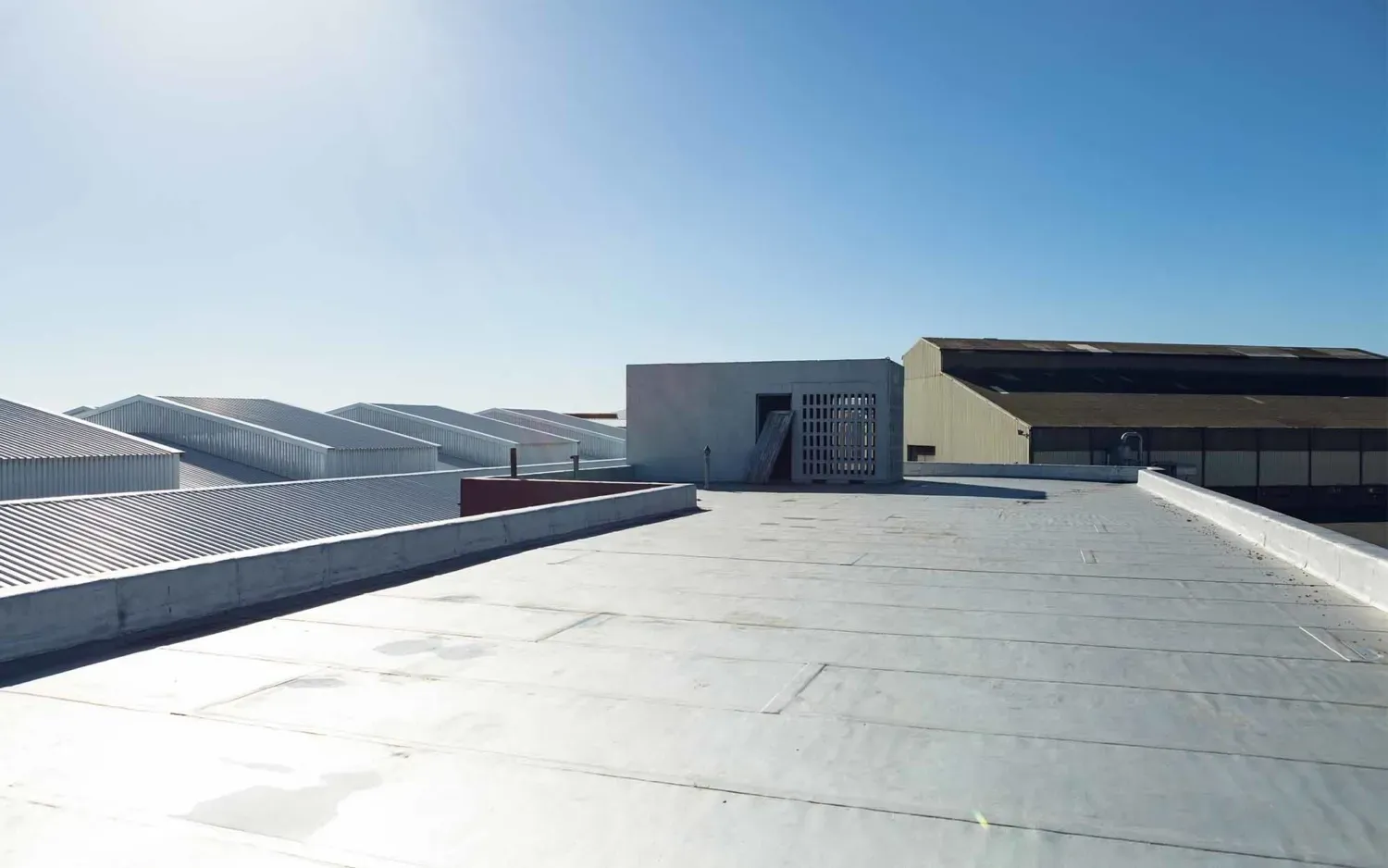 Top view of a white industrial warehouse roof
