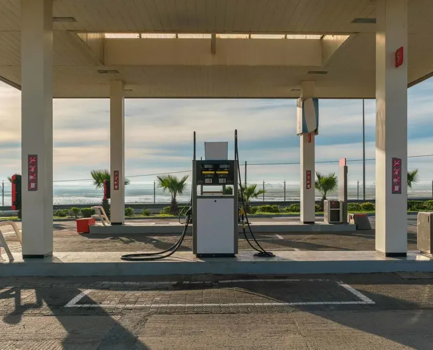 Under a gas station rooftop in the evening