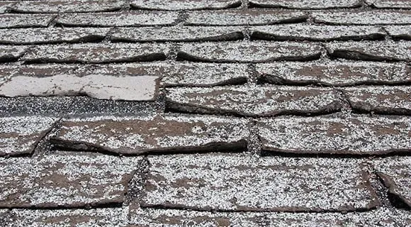 apartment building aging shingle roof