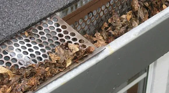 clogged residential roof gutter system