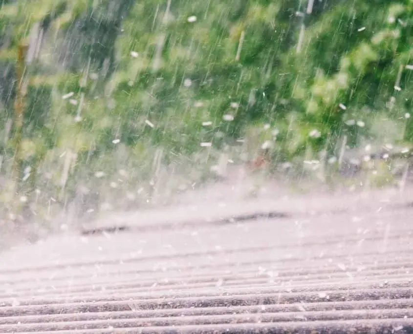 summer rain with hail falls on the roof of slate